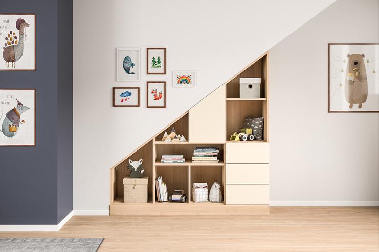 Kreativ unter einer Treppe eingepasster Schrank nach Maß, mit offenen Fächern und Schubladen, gefüllt mit Büchern und Spielzeug, in einem Kinderzimmer.